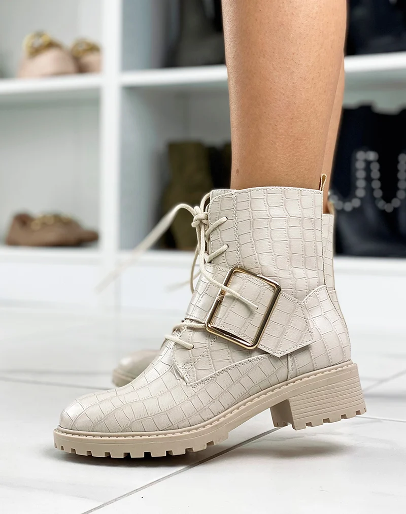 Bottines beiges effet croco ornées d’une grosse boucle dorée
