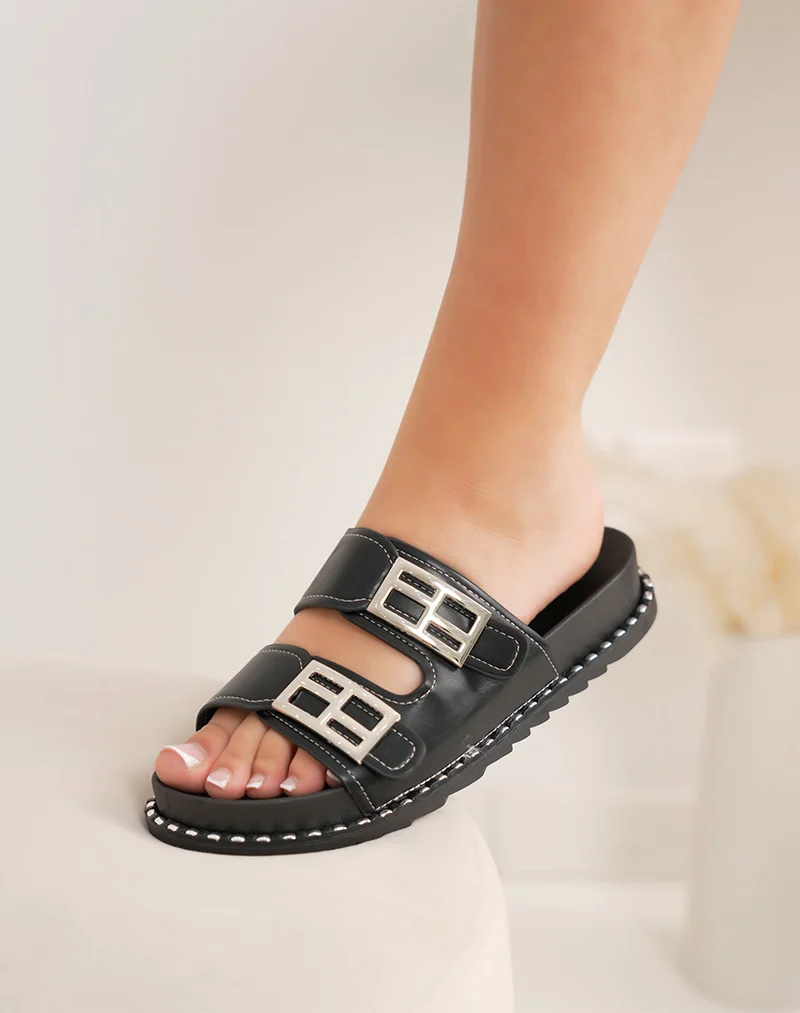 Mules femme noires tendance avec grosses boucles argentées et coutures contrastées